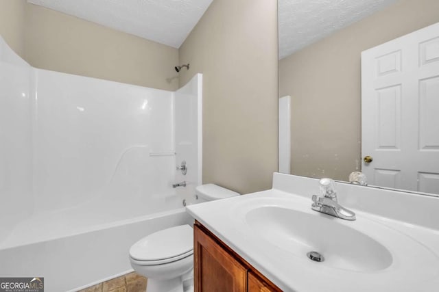 full bathroom featuring bathtub / shower combination, vanity, toilet, and a textured ceiling