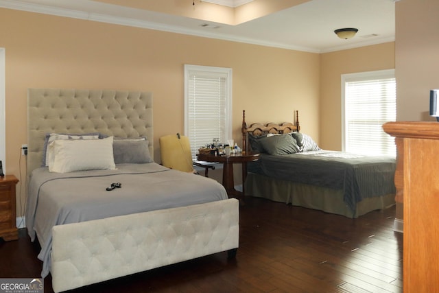 bedroom featuring ornamental molding, dark hardwood / wood-style floors, and a skylight