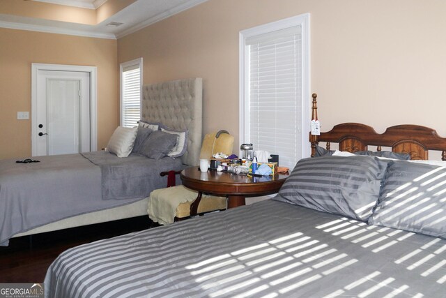 bedroom featuring crown molding and dark hardwood / wood-style flooring