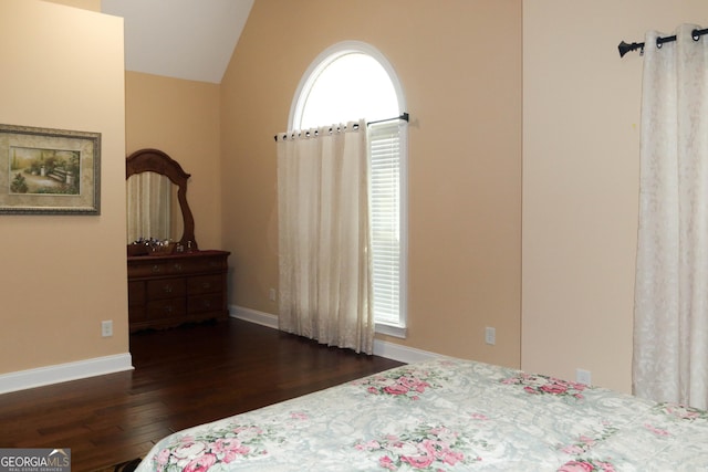 bedroom featuring vaulted ceiling and dark wood-type flooring