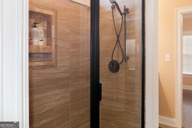 bathroom with a tile shower