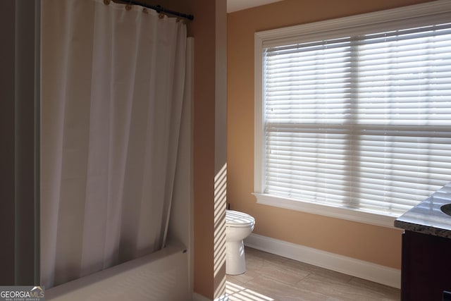 bathroom with vanity, toilet, and plenty of natural light