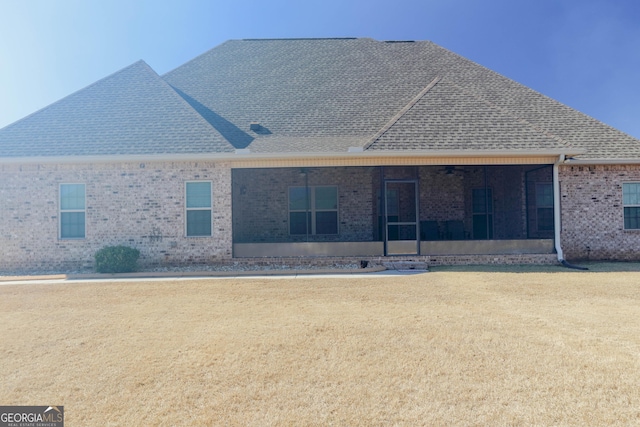 back of property featuring a yard