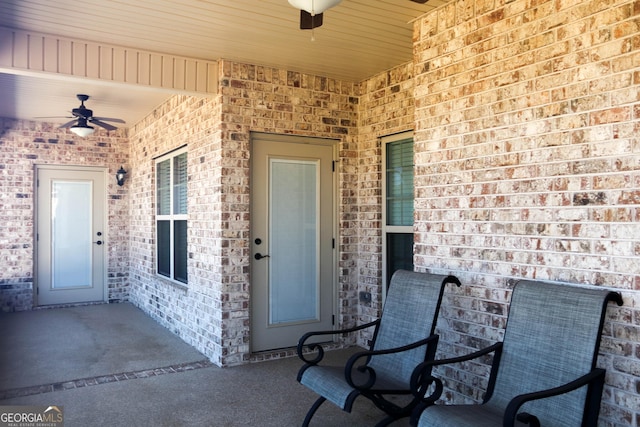 view of exterior entry with a patio and ceiling fan