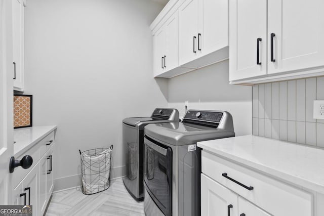 washroom with cabinets and independent washer and dryer