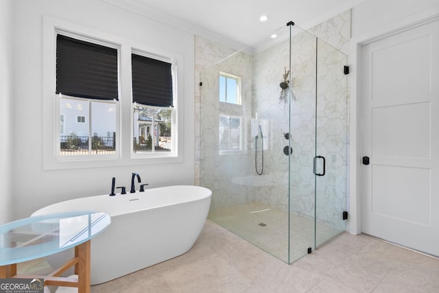 bathroom with ornamental molding, independent shower and bath, and a healthy amount of sunlight