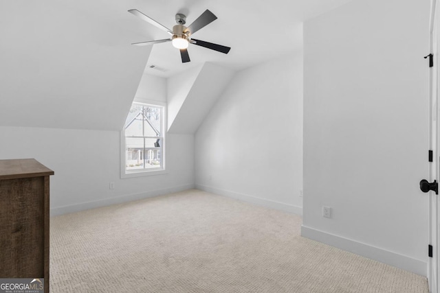 additional living space with lofted ceiling, light colored carpet, and ceiling fan