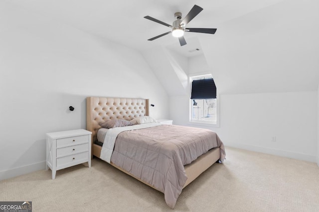 bedroom with vaulted ceiling, light colored carpet, and ceiling fan