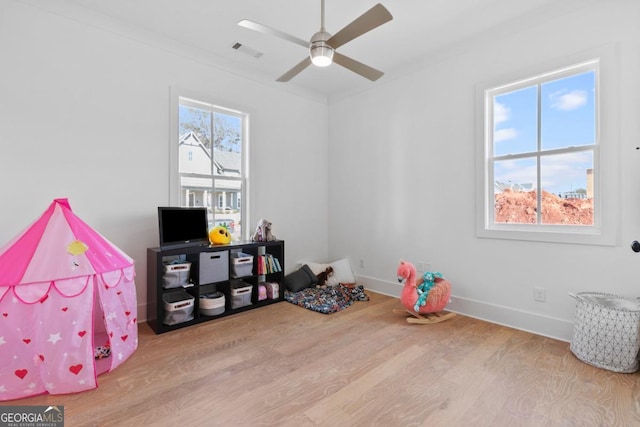 game room with ceiling fan and light hardwood / wood-style flooring