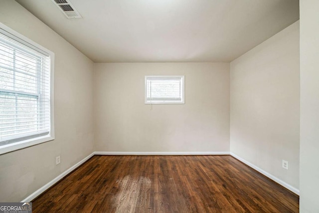 unfurnished room featuring dark hardwood / wood-style flooring