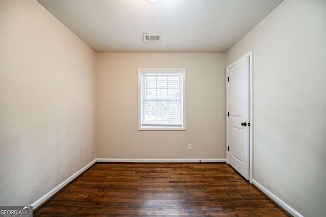 empty room featuring dark wood-type flooring