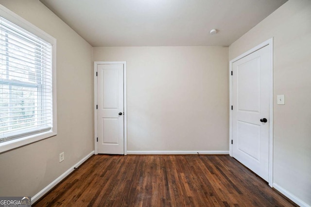 empty room featuring dark hardwood / wood-style flooring