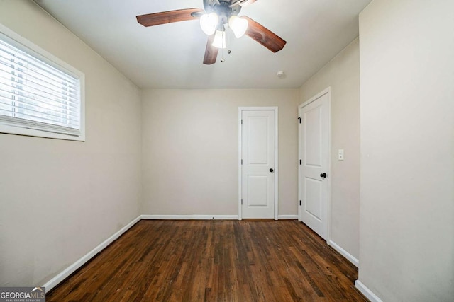 spare room featuring ceiling fan and dark hardwood / wood-style floors