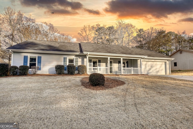 ranch-style house featuring a porch and a garage