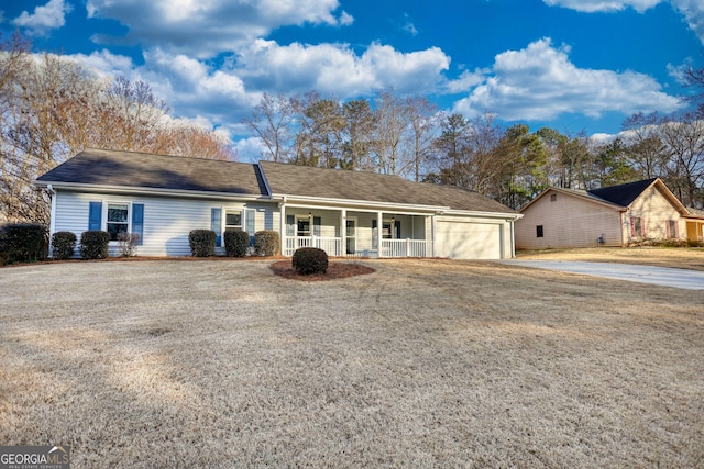 ranch-style house with a garage and covered porch