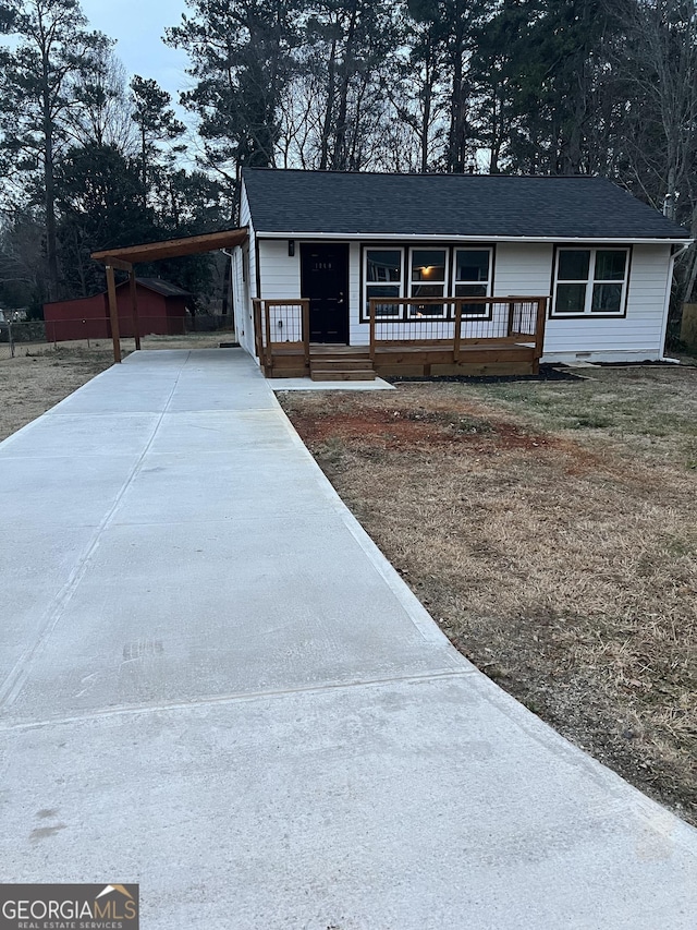 view of front facade with a carport and covered porch