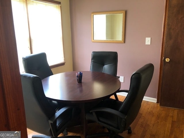 dining space with light hardwood / wood-style flooring and a healthy amount of sunlight