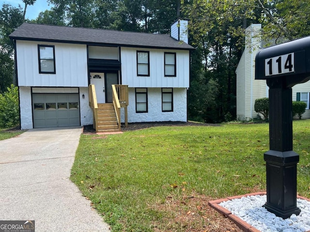 raised ranch with a garage and a front yard