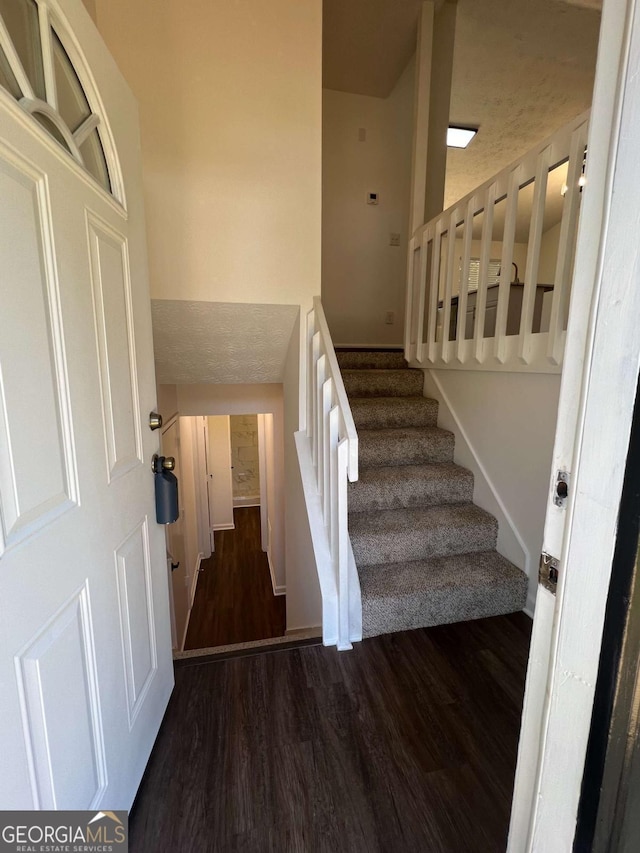 staircase with wood-type flooring