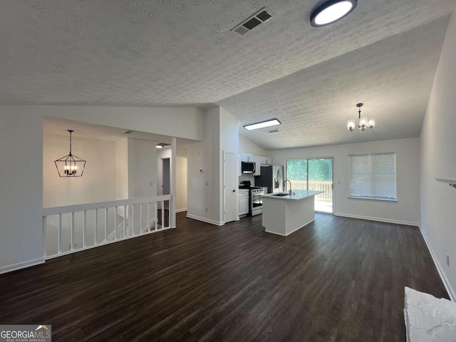 kitchen featuring appliances with stainless steel finishes, decorative light fixtures, a chandelier, and white cabinets