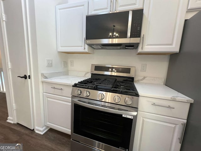 kitchen with white cabinetry, light stone countertops, and stainless steel appliances