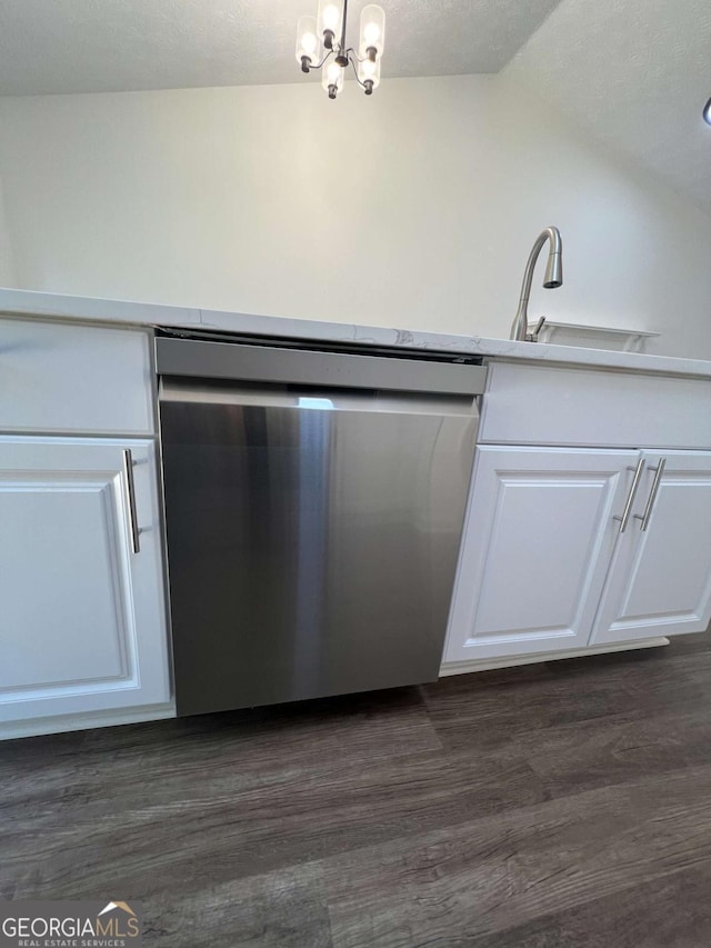 kitchen with lofted ceiling, dark hardwood / wood-style flooring, dishwasher, and white cabinets