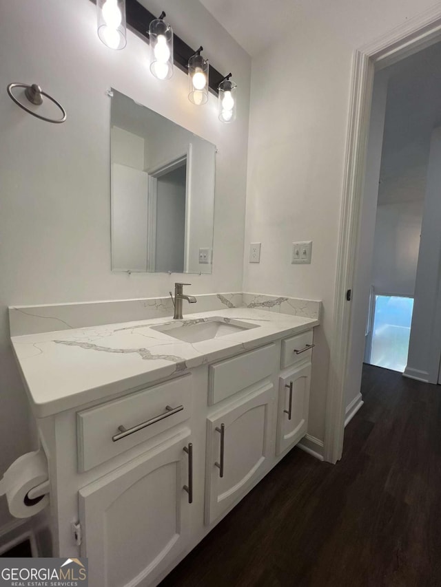 bathroom with vanity and wood-type flooring