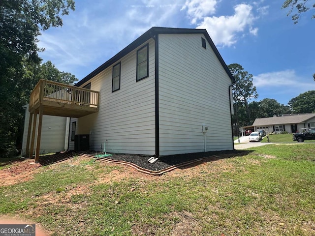 view of home's exterior featuring a deck, central air condition unit, and a lawn