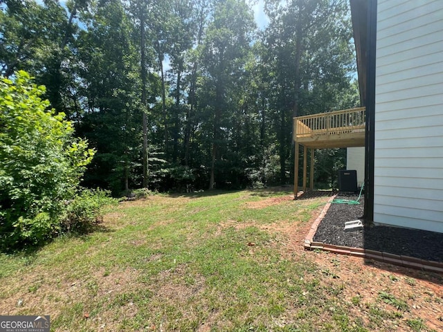 view of yard featuring central AC and a deck