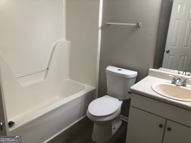 full bathroom featuring vanity, bathing tub / shower combination, and toilet