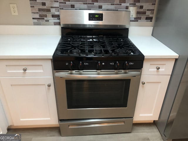 details featuring decorative backsplash and stainless steel appliances