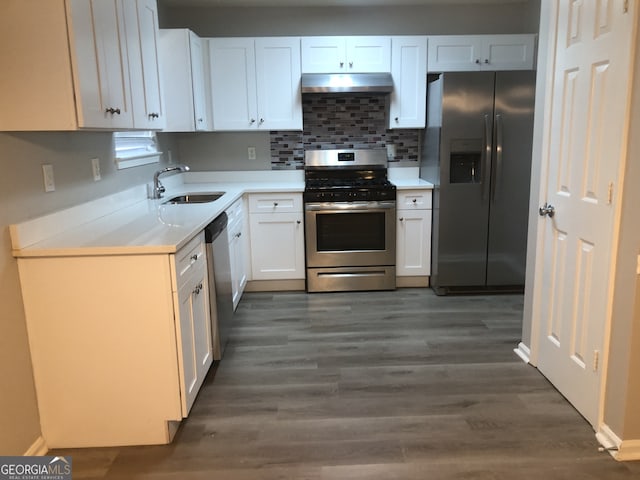 kitchen with appliances with stainless steel finishes, dark hardwood / wood-style flooring, sink, and white cabinets