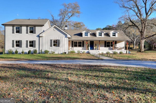 view of front of house with a porch and a front yard