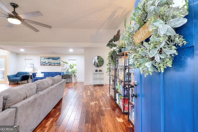 living room with dark hardwood / wood-style flooring and ceiling fan