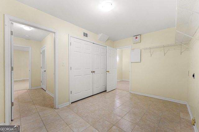 unfurnished bedroom with light tile patterned floors