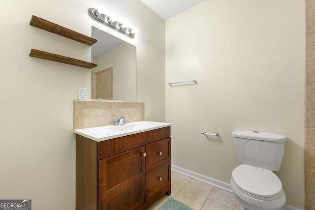 bathroom featuring tasteful backsplash, vanity, toilet, and tile patterned flooring