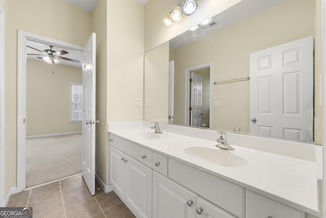 bathroom with tile patterned flooring, vanity, and ceiling fan