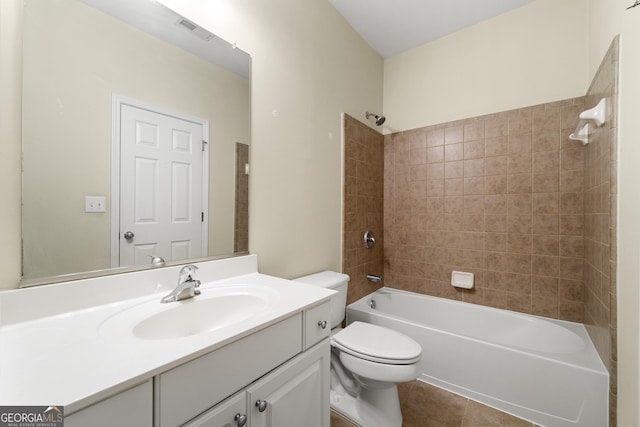 full bathroom with tiled shower / bath, vanity, toilet, and tile patterned flooring