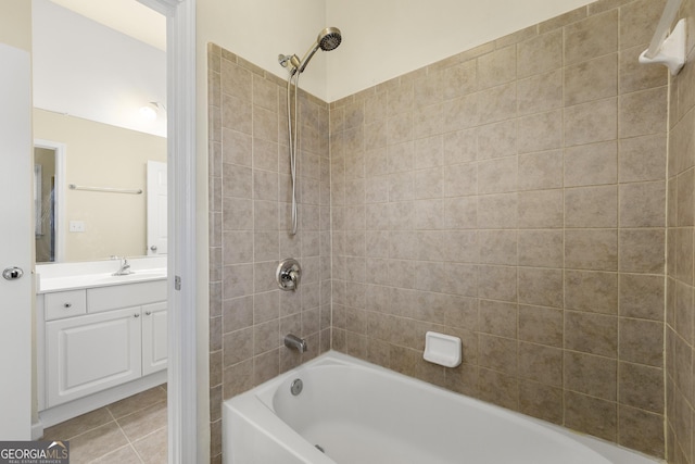 bathroom with tile patterned floors, tiled shower / bath combo, and vanity