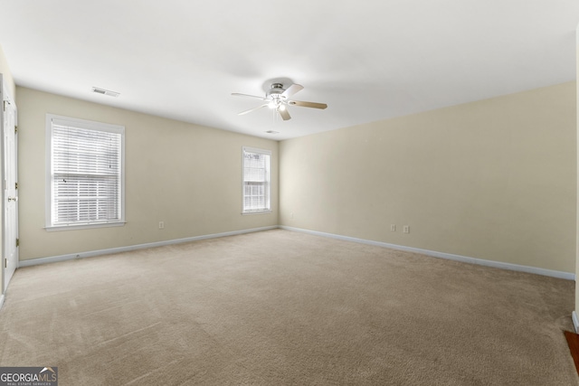 empty room with light carpet and ceiling fan