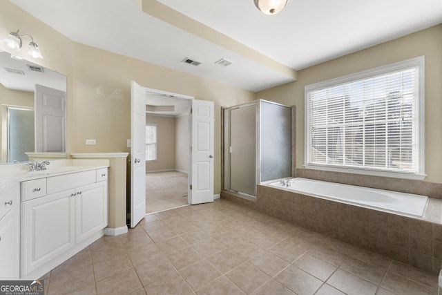 bathroom with tile patterned flooring, vanity, and independent shower and bath