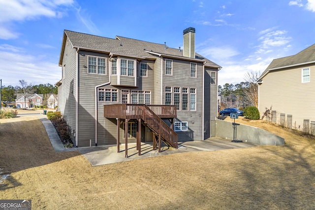 back of property featuring a patio area and a deck