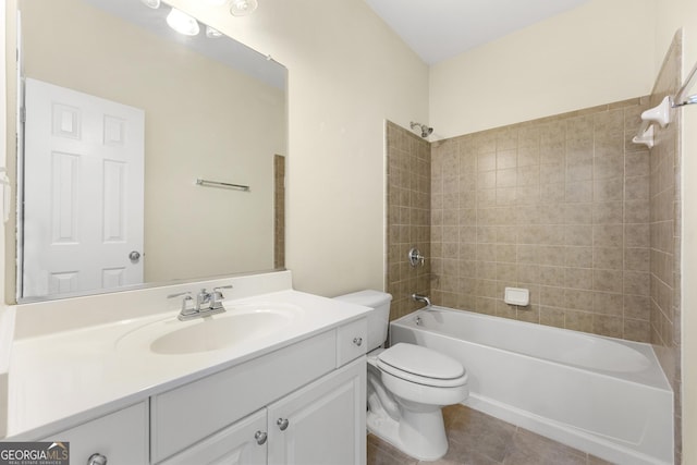 full bathroom featuring tiled shower / bath, tile patterned floors, toilet, and vanity