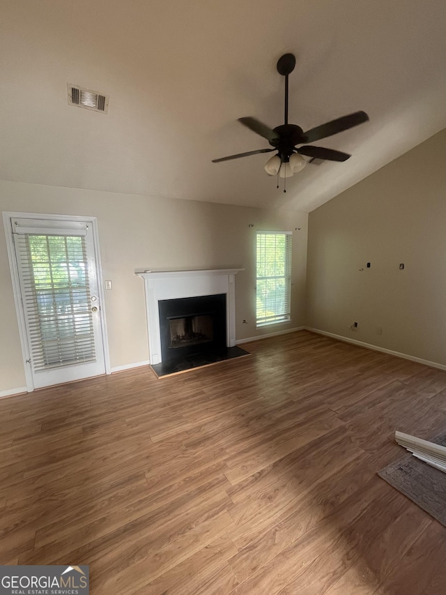 unfurnished living room with plenty of natural light, a fireplace, visible vents, and light wood-style flooring