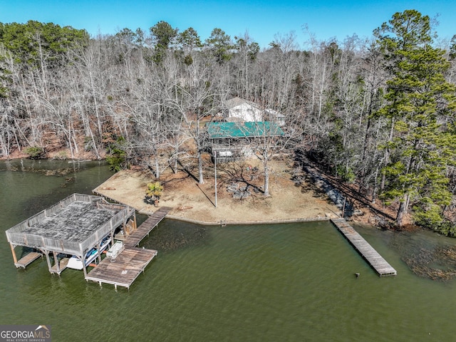 aerial view featuring a water view and a forest view