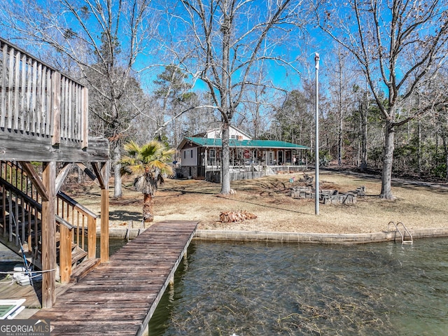 dock area featuring a water view and stairway