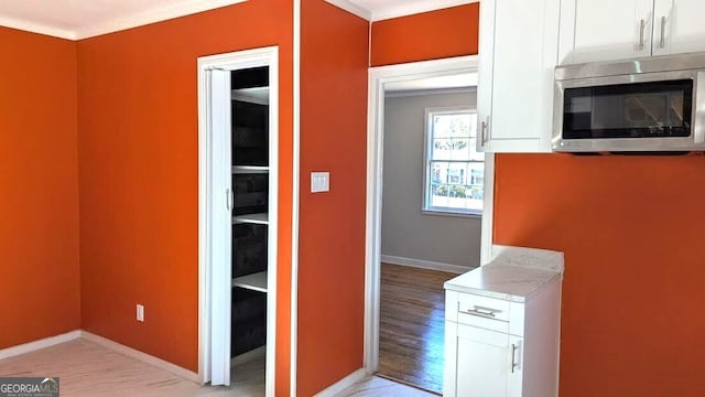 kitchen with crown molding and white cabinets