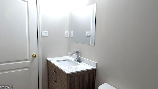 bathroom with vanity and toilet