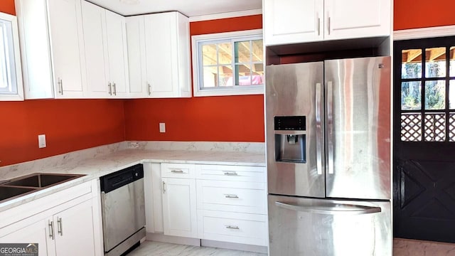 kitchen with appliances with stainless steel finishes, light stone countertops, and white cabinets