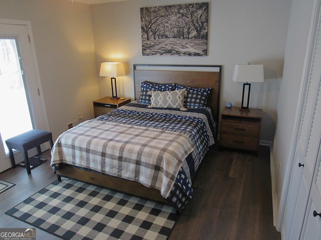 bedroom with dark hardwood / wood-style flooring